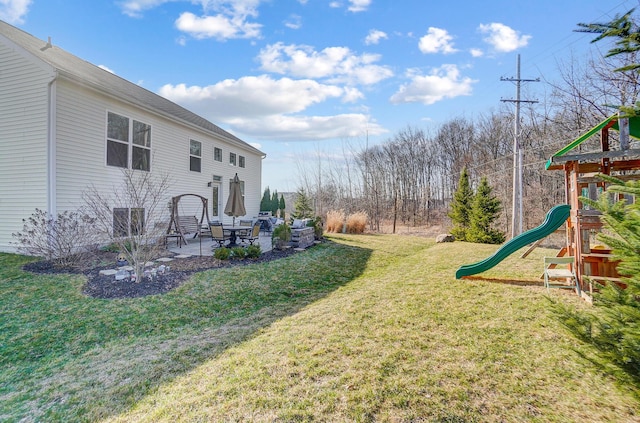 view of yard with a patio and a playground