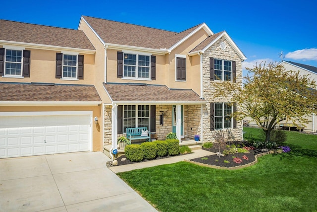 6148 Ryan Woods Way, Hilliard, OH 43026 - view of front facade with stucco siding, a front lawn, stone siding, and covered porch