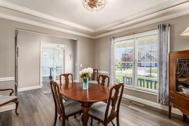 6148 Ryan Woods Way, Hilliard, OH 43026 - dining room with baseboards, wood finished floors, visible vents, and crown molding