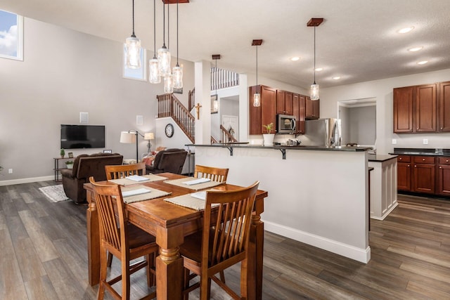 6148 Ryan Woods Way, Hilliard, OH 43026 - dining room featuring stairway, dark wood finished floors, baseboards, and recessed lighting