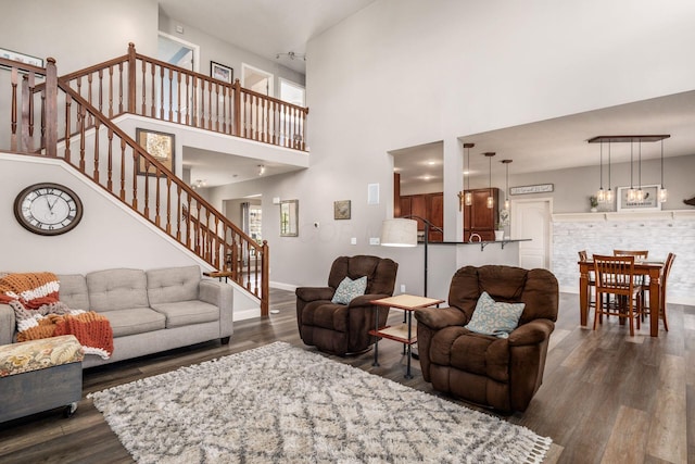 6148 Ryan Woods Way, Hilliard, OH 43026 - living area with baseboards, stairway, a high ceiling, and dark wood-style floors