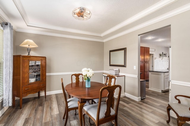 6148 Ryan Woods Way, Hilliard, OH 43026 - dining area featuring baseboards, dark wood-type flooring, and crown molding