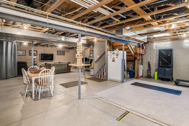 6148 Ryan Woods Way, Hilliard, OH 43026 - below grade area featuring freestanding refrigerator, stairway, and brick wall