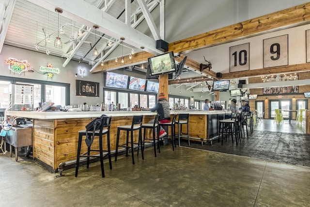 6148 Ryan Woods Way, Hilliard, OH 43026 - bar featuring a workshop area, a healthy amount of sunlight, beam ceiling, and finished concrete flooring