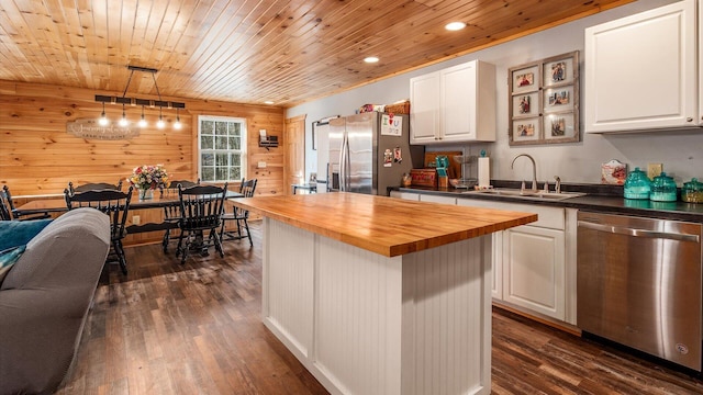 kitchen featuring a sink, white cabinetry, appliances with stainless steel finishes, wooden counters, and dark wood-style flooring