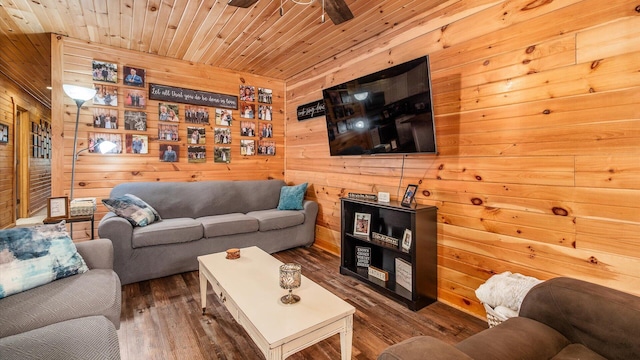 living room featuring a ceiling fan, wood finished floors, wooden walls, and wood ceiling