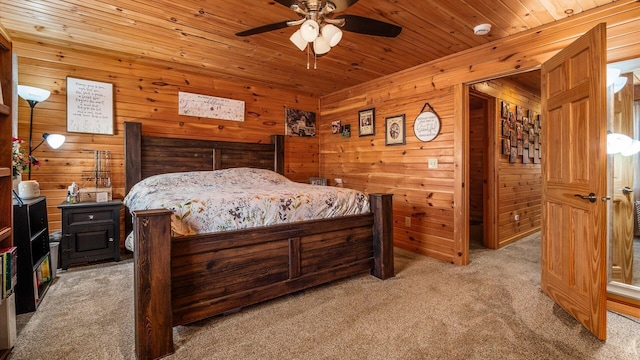 bedroom with wooden walls, wood ceiling, and light carpet