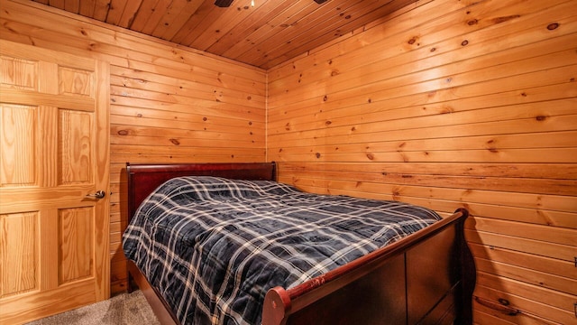 bedroom with wooden ceiling, wood walls, and a sauna