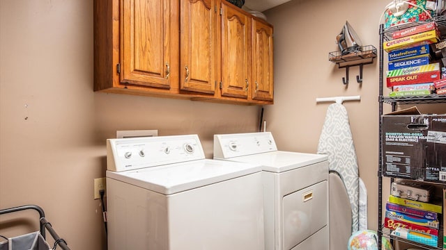 laundry room with cabinet space and washing machine and dryer