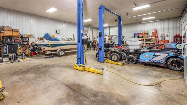 garage featuring a workshop area and metal wall