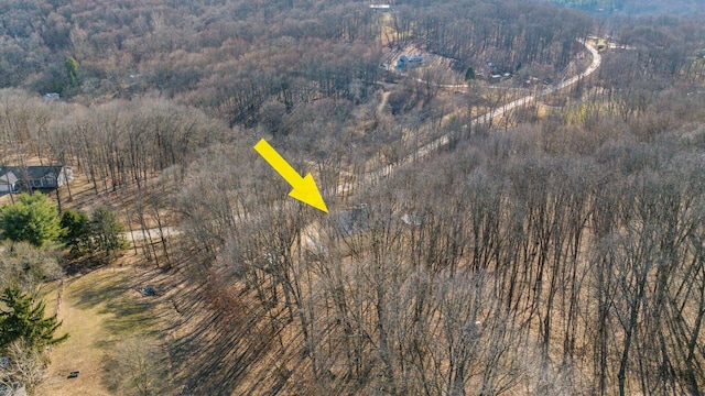 aerial view featuring a wooded view