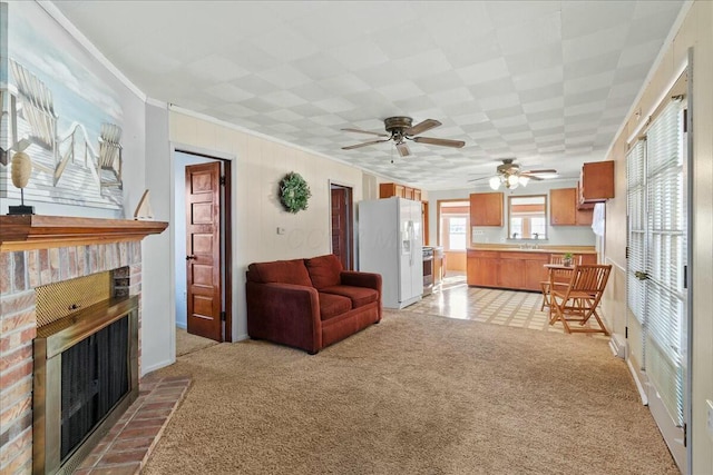 living room with a brick fireplace, ornamental molding, and light carpet