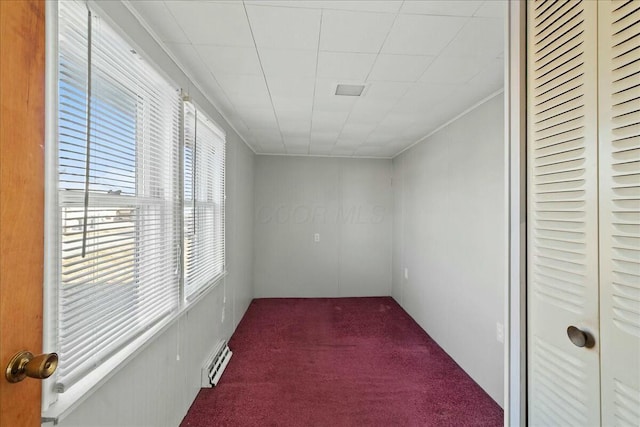 unfurnished room with a baseboard radiator, carpet, and crown molding