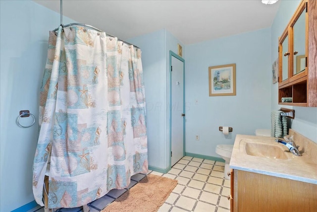 bathroom with baseboards, toilet, a shower with curtain, tile patterned floors, and vanity