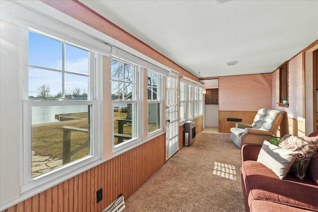 sunroom featuring visible vents and heating unit