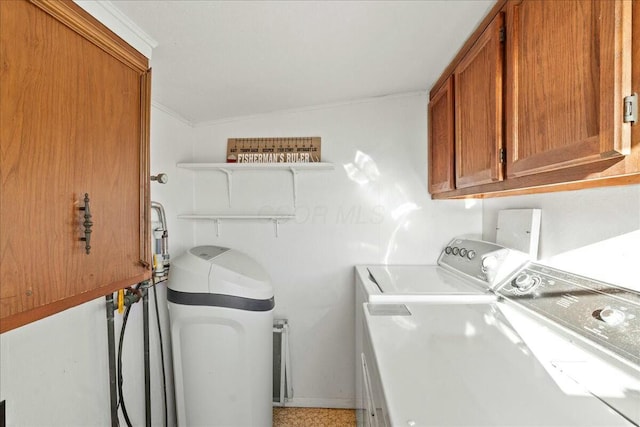 clothes washing area with cabinet space and washer and clothes dryer