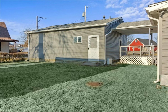 rear view of house with a lawn and entry steps