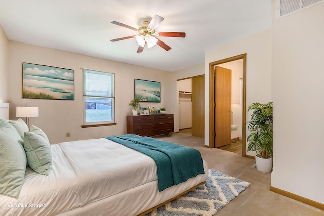 bedroom featuring visible vents, ceiling fan, baseboards, ensuite bathroom, and a closet