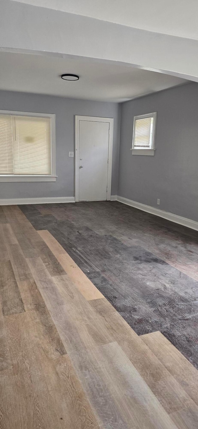 foyer entrance featuring wood finished floors and baseboards