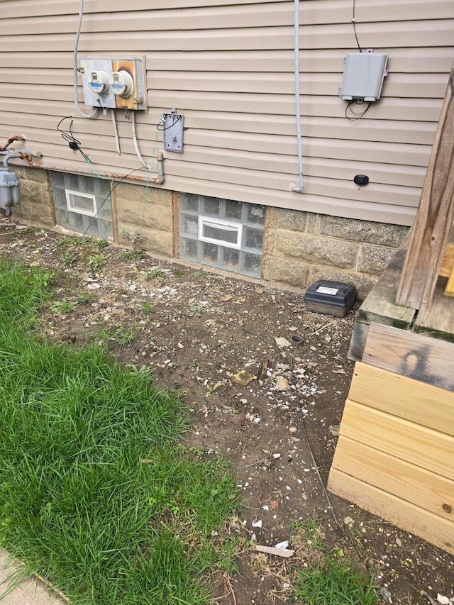 exterior details featuring electric meter and gas meter