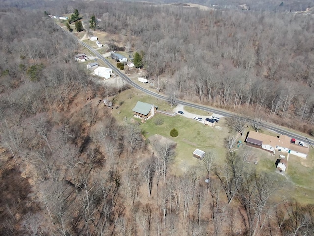 birds eye view of property featuring a view of trees