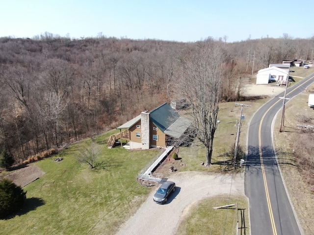 birds eye view of property with a wooded view