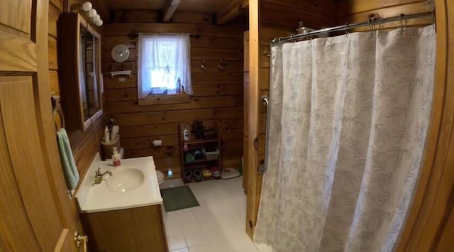 full bath with curtained shower, wood walls, and vanity