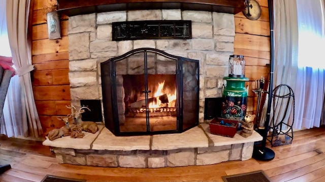 room details featuring wood finished floors, a fireplace, and visible vents