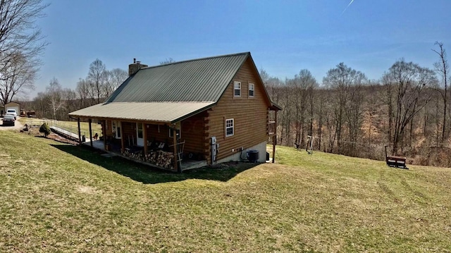 view of property exterior featuring central AC, log siding, a lawn, a chimney, and metal roof