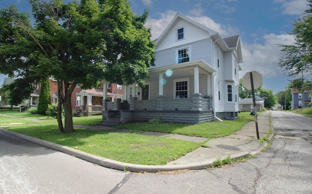 view of front of property with a front yard and covered porch