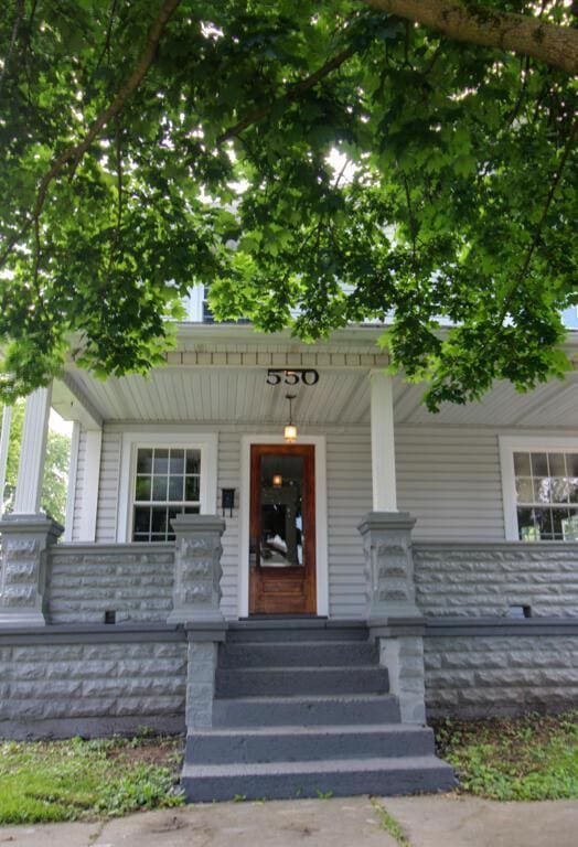 view of exterior entry featuring a porch