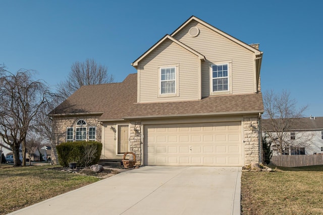 traditional-style home with fence, roof with shingles, concrete driveway, a front lawn, and stone siding