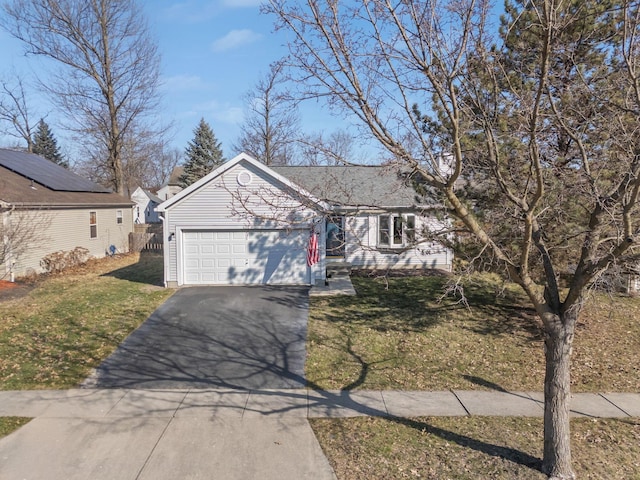 ranch-style home featuring a front lawn, an attached garage, and aphalt driveway