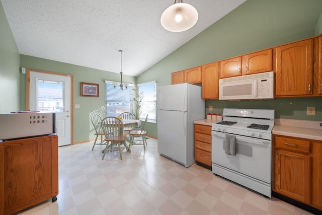 kitchen featuring white appliances, light floors, lofted ceiling, light countertops, and a chandelier