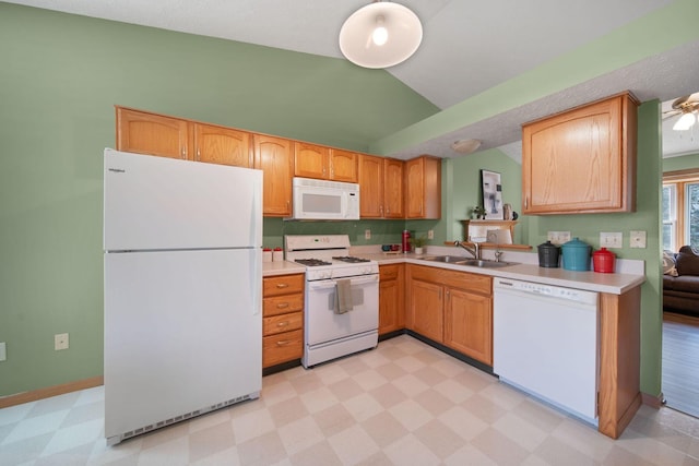 kitchen with light floors, white appliances, lofted ceiling, and a sink