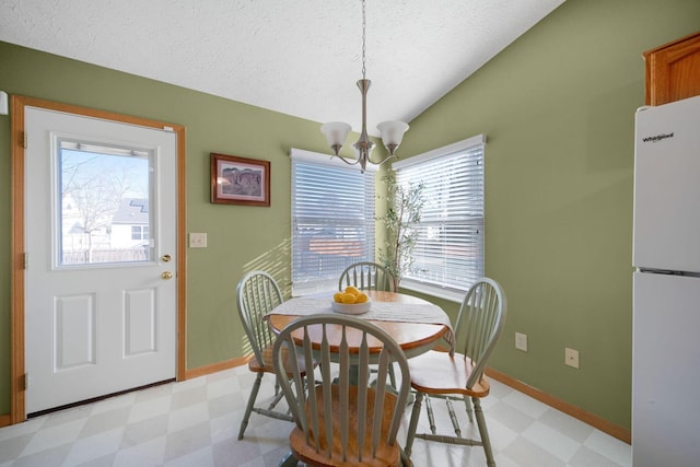 dining room with a notable chandelier, light floors, and plenty of natural light