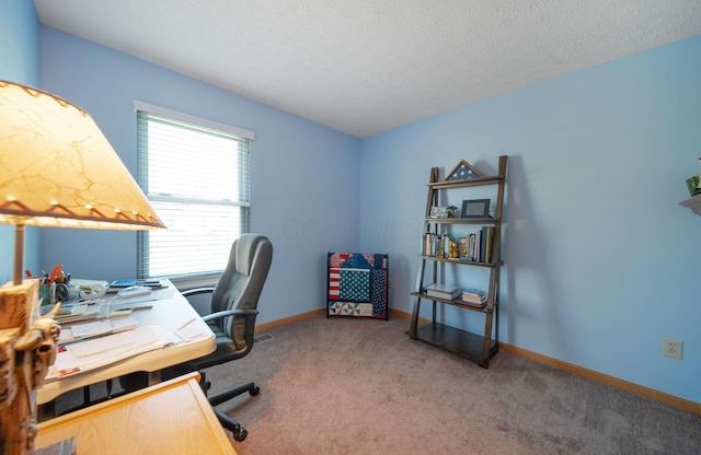 carpeted home office with a textured ceiling and baseboards