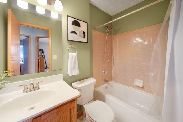 bathroom featuring toilet, shower / bath combo, vanity, and a textured ceiling