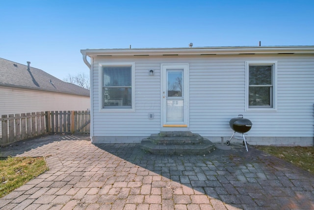 back of property with a patio, entry steps, and fence