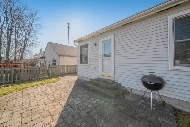 view of patio / terrace featuring fence, a grill, and entry steps