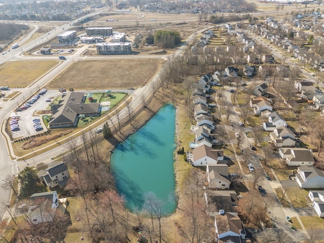 drone / aerial view with a residential view and a water view