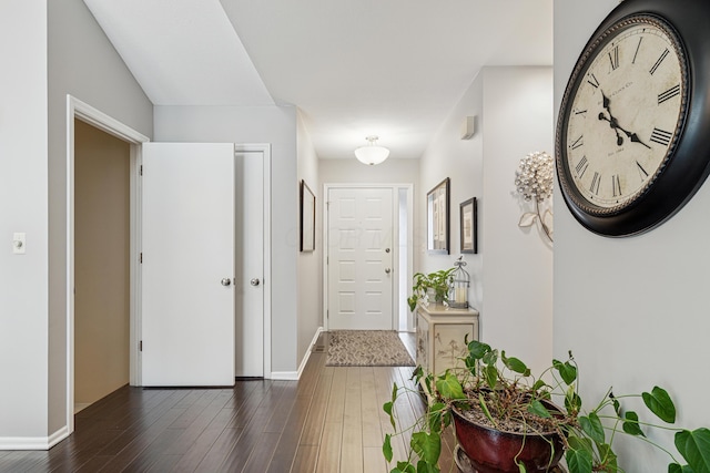 entryway with baseboards and dark wood-style floors