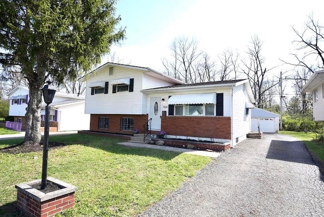 1664 Deporres Dr, Columbus, OH 43219 - split level home featuring an outbuilding, a detached garage, entry steps, a front yard, and brick siding