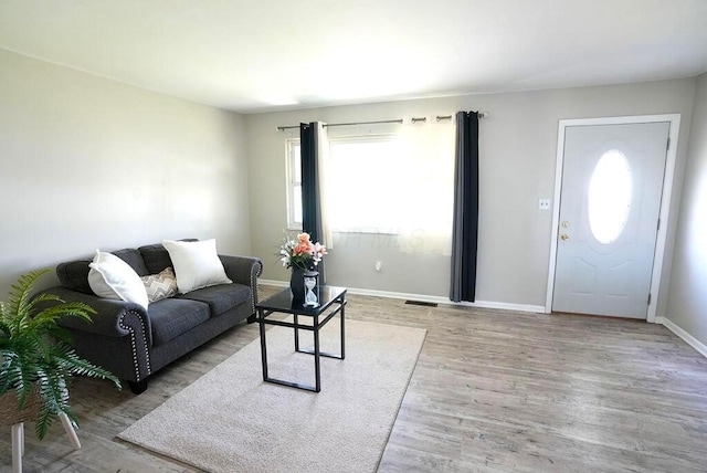 1664 Deporres Dr, Columbus, OH 43219 - living area featuring visible vents, baseboards, and wood finished floors