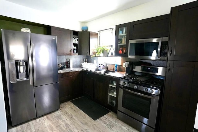 1664 Deporres Dr, Columbus, OH 43219 - kitchen with a sink, open shelves, light wood-type flooring, and appliances with stainless steel finishes