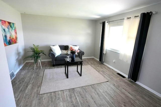 1664 Deporres Dr, Columbus, OH 43219 - living area featuring visible vents, baseboards, and wood finished floors