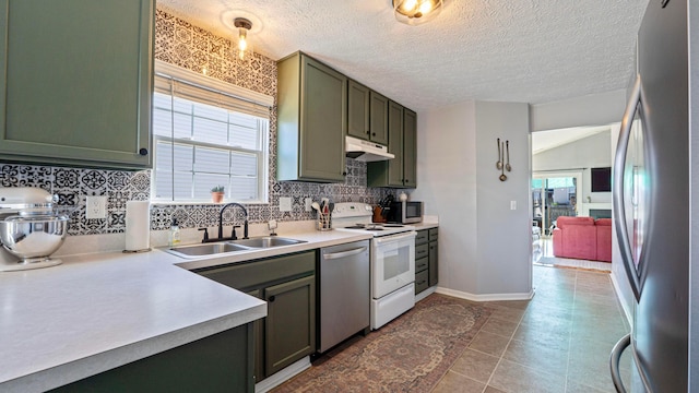 kitchen featuring a sink, plenty of natural light, appliances with stainless steel finishes, and under cabinet range hood