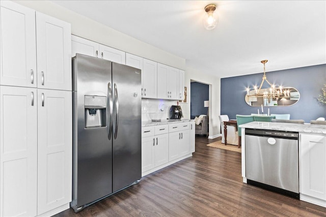 kitchen with an inviting chandelier, dark wood-type flooring, white cabinetry, and stainless steel appliances