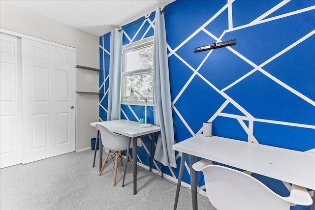 carpeted home office featuring baseboards