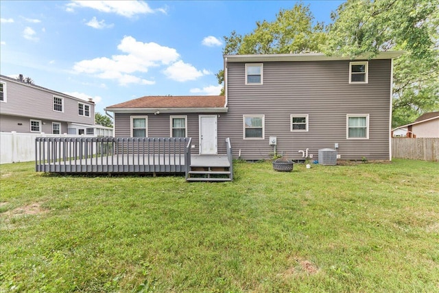 back of house featuring cooling unit, a deck, a yard, and fence